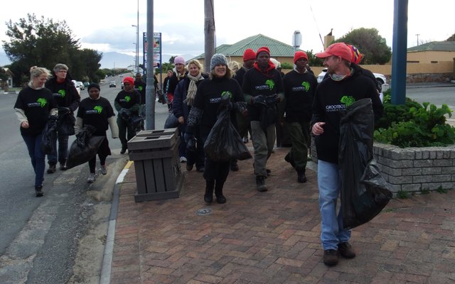 Staff members of the Grootbos Foundation on their way to the Municipal Offices while picking up litter
